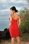 Denise Milani posing outdoor in red dress